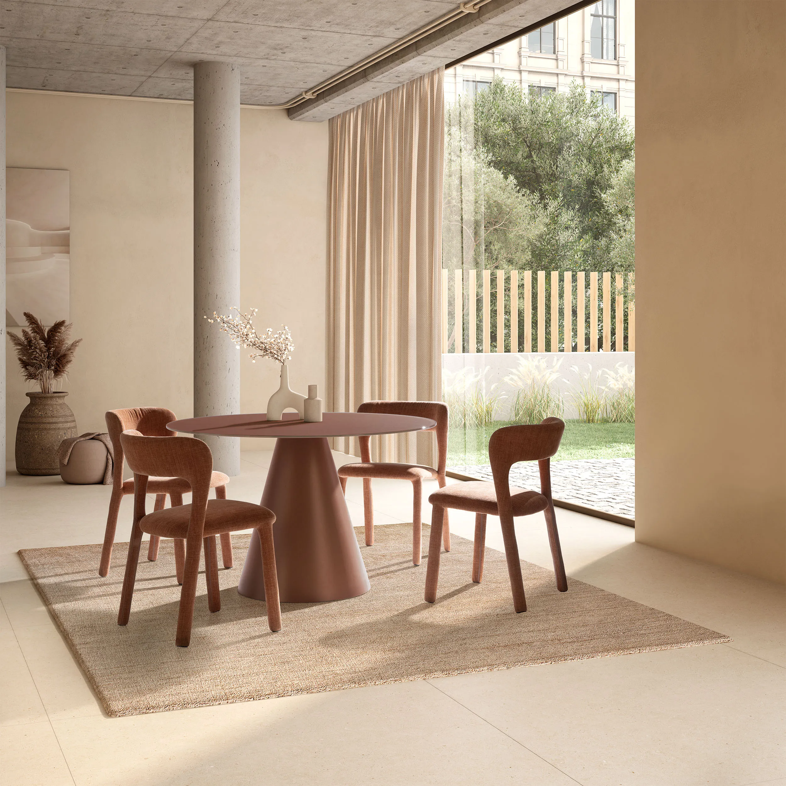 Mesa Vida redonda de comedor en color terracota con base central a juego y diseño contemporáneo