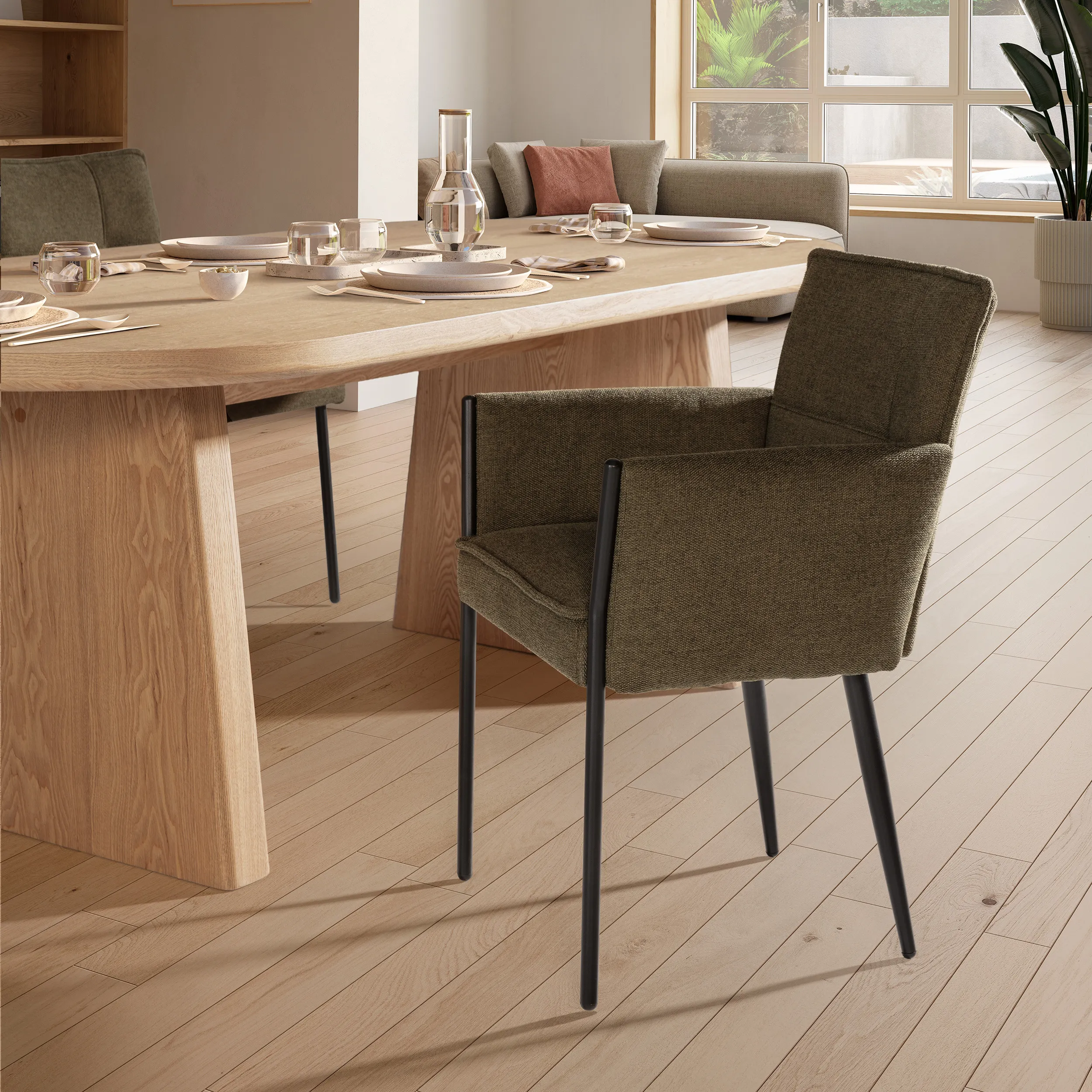 Sillón Vesta Verde tapizado con reposabrazos y estructura metálica negra